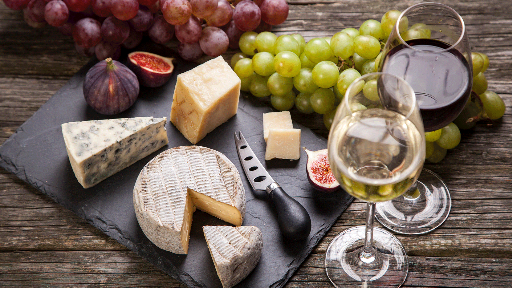Cheese and wine platter with grapes